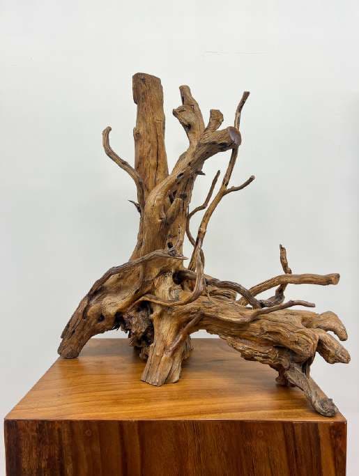 Natural-cut leather wood sculpture on a pedestal