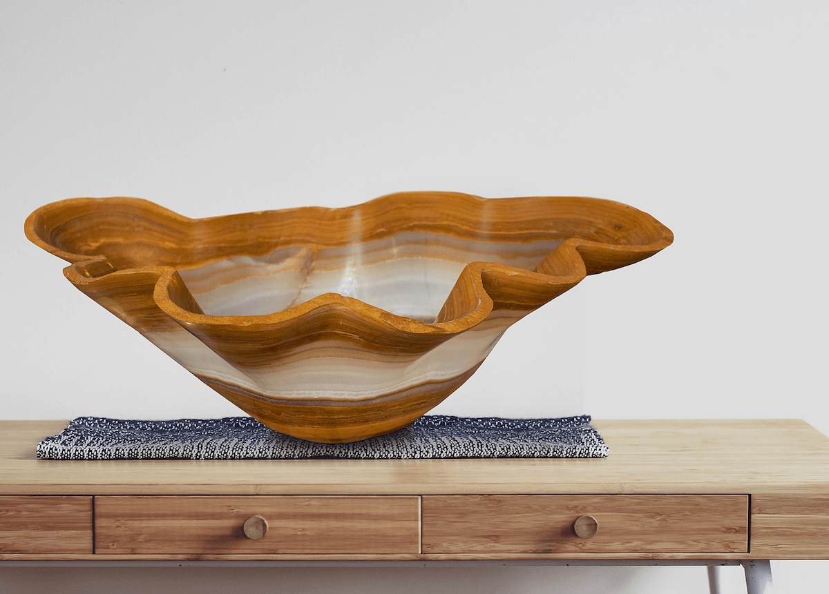Honey onyx bowl on a wooden sideboard