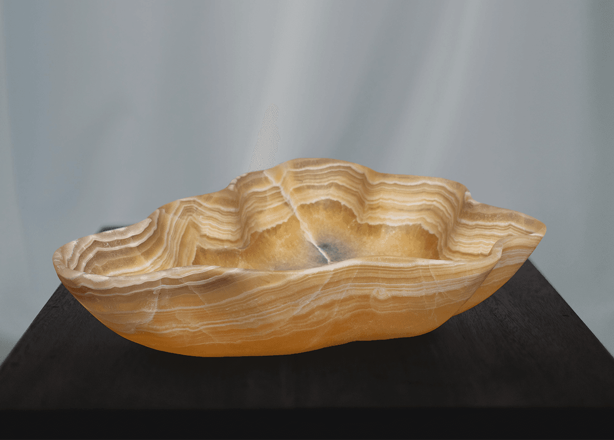 Banded onyx bowl on a dark pedestal