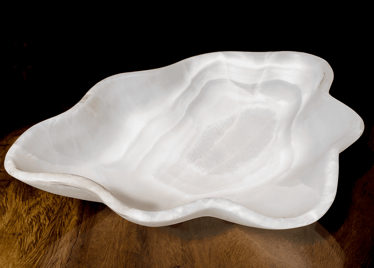 White onyx bowl glowing against a dark ground
